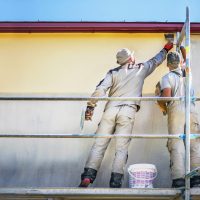 Two,Builders,On,Safety,Scaffolding,Make,Yellow,Decorative,Plaster,On